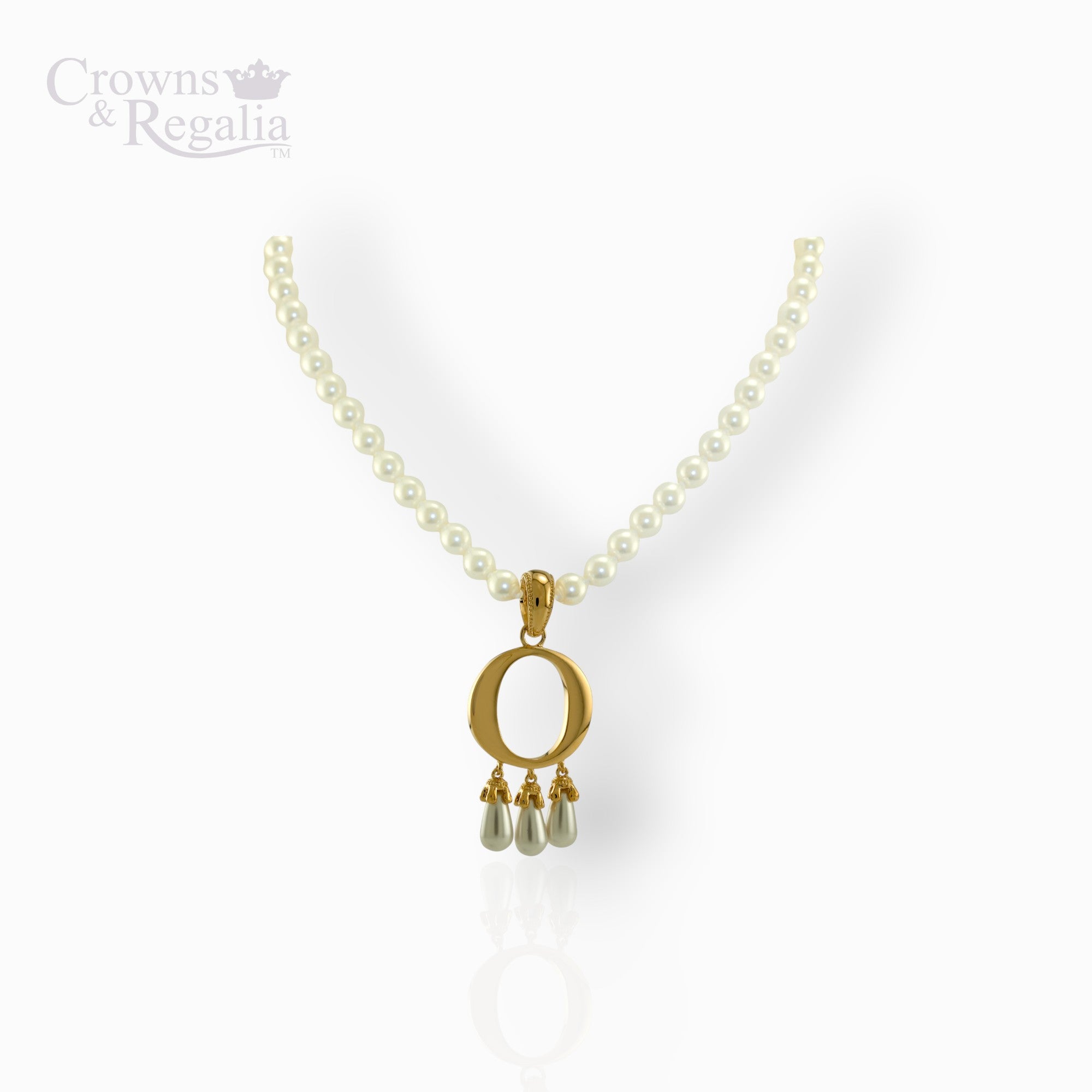 Pearl necklace with a gold pendant featuring three droplets on a white background, branded 'Crowns & Regalia'.