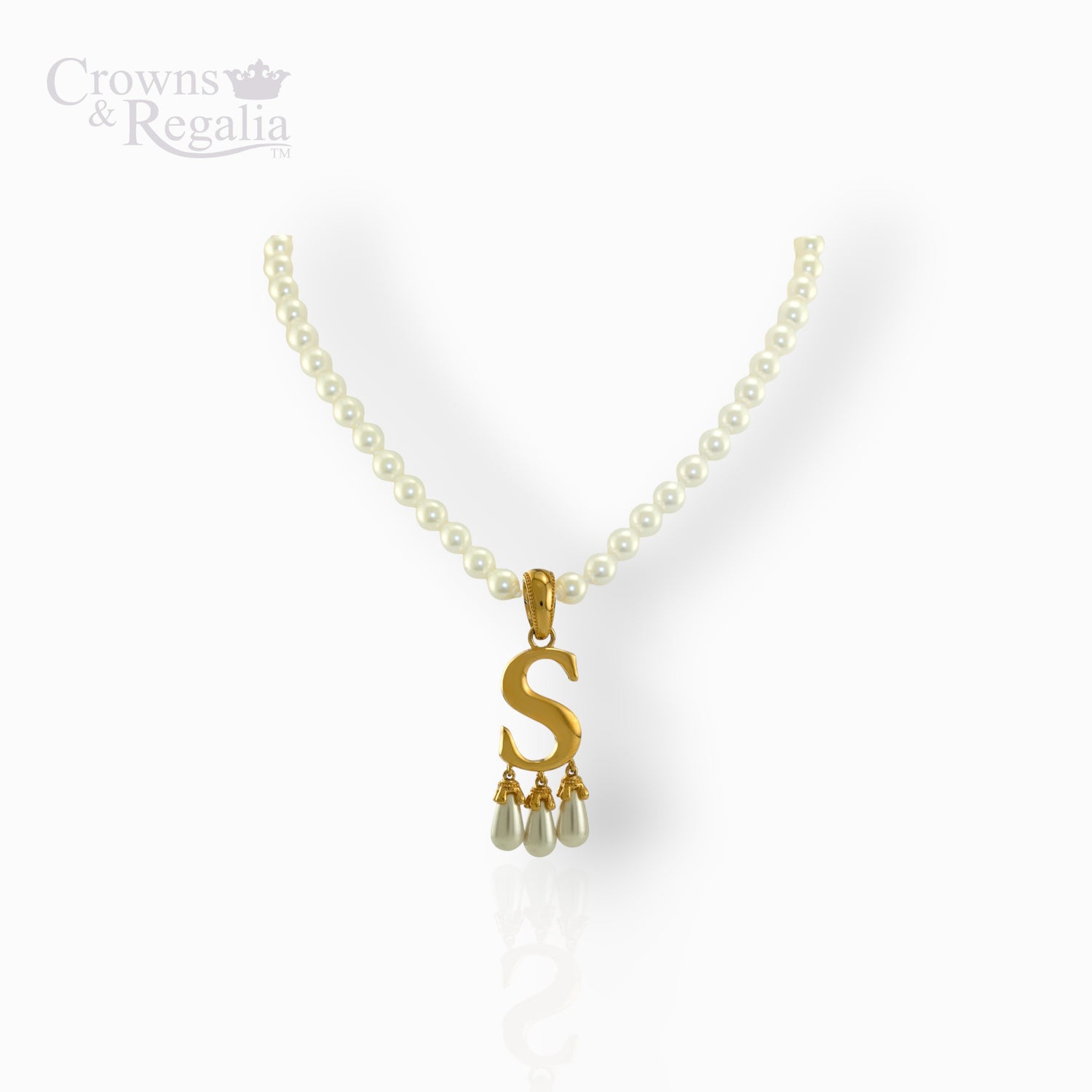 Gold necklace with 'S' pendant and pearl drops on a white background.