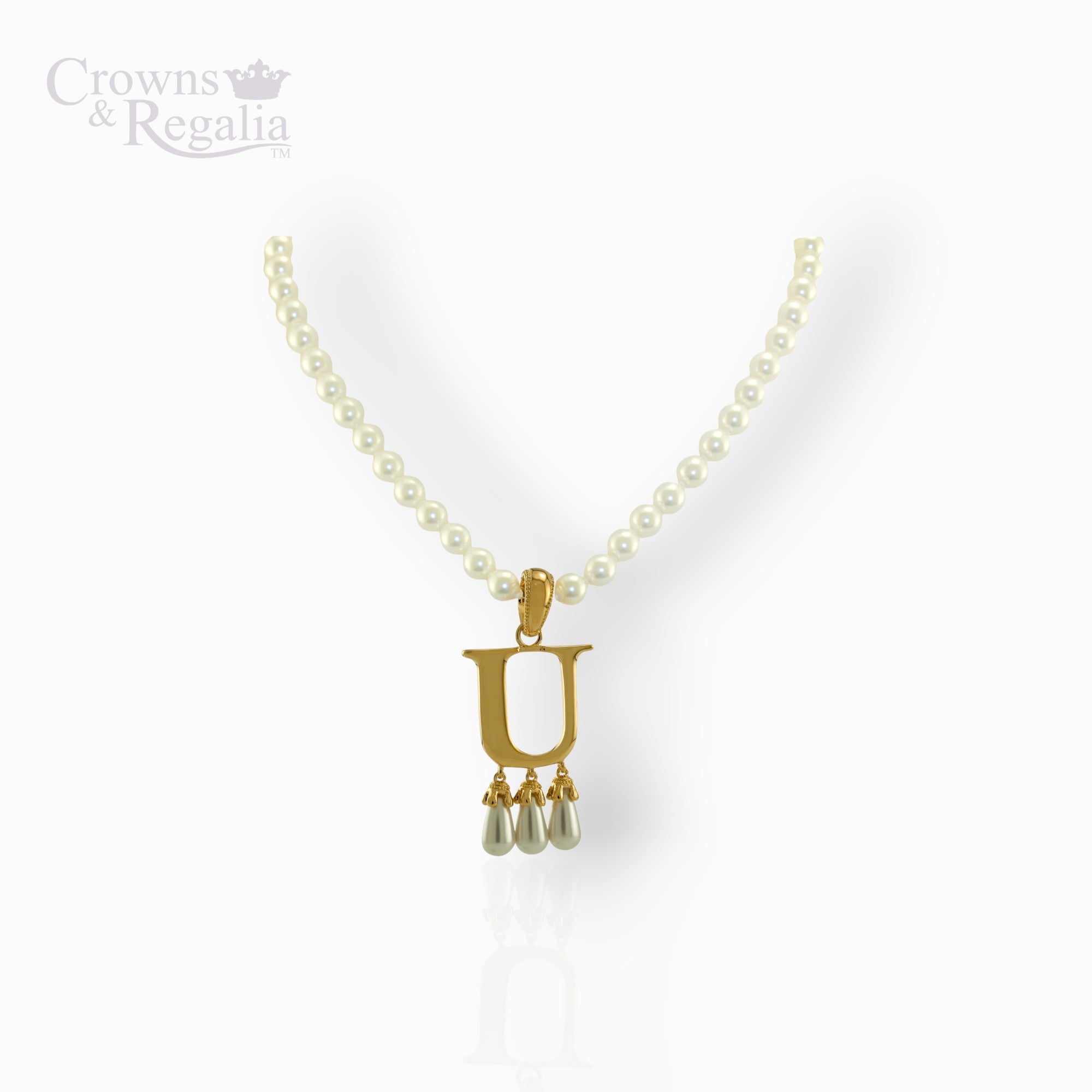 Pearl necklace with a gold pendant on a white background, branded 'Crowns & Regalia'.