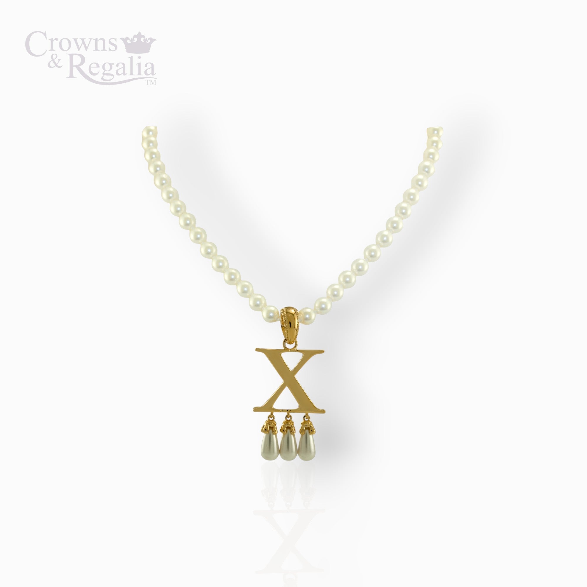 Pearl necklace with a gold pendant featuring the letter 'X' on a white background, branded 'Crowns & Regalia'.