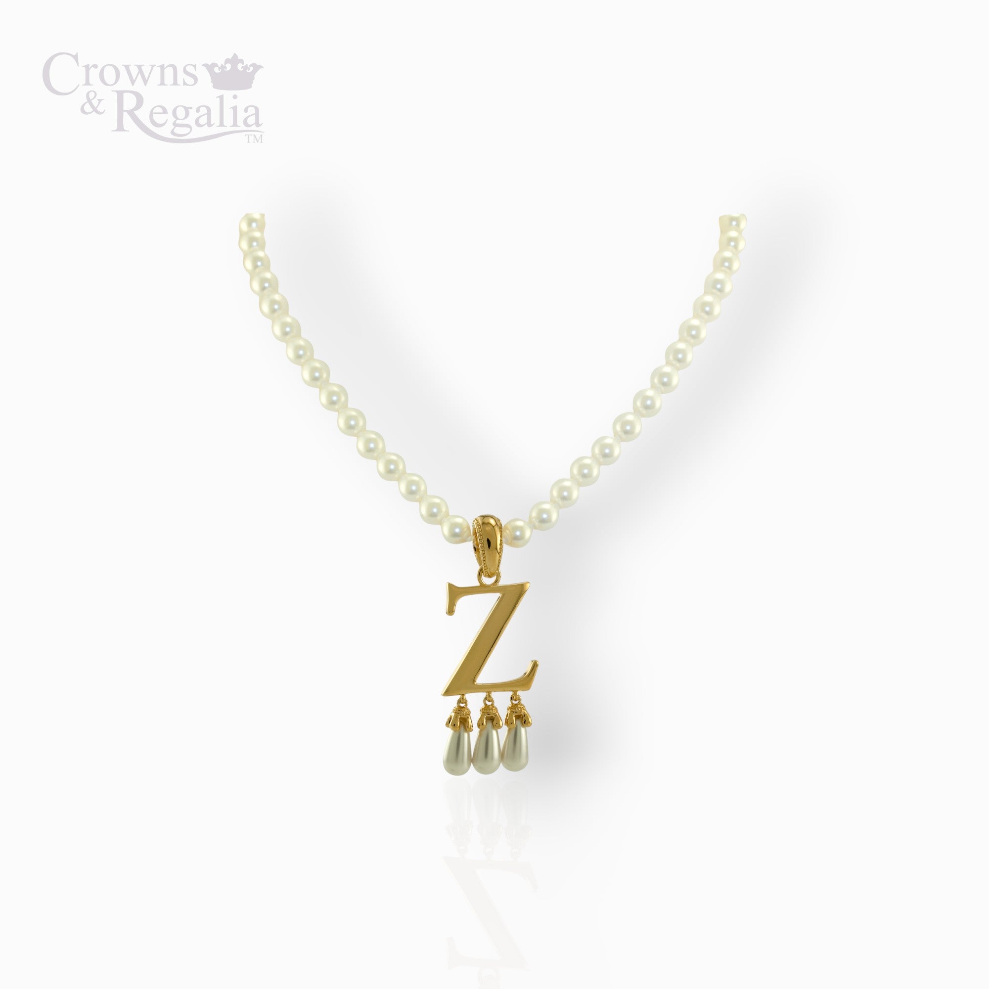 Pearl necklace with a gold pendant featuring the letter 'Z' on a white background, branded 'Crowns & Regalia'.